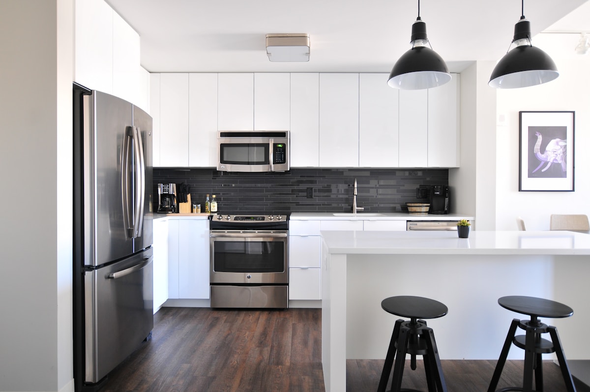 A kitchen with appliances and household belongings.