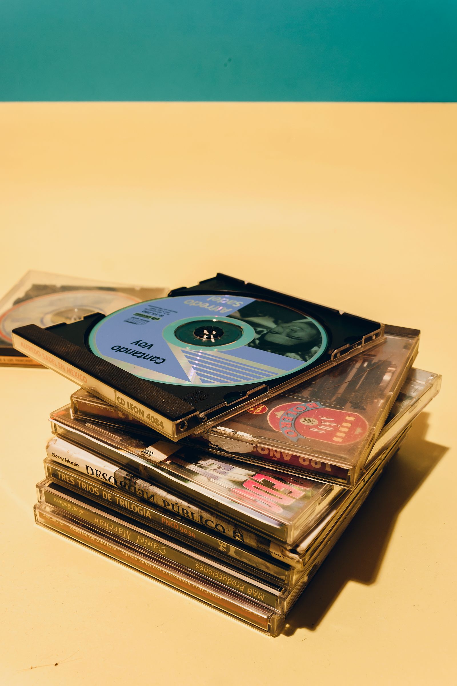 A stack of CDs in jewel cases.
